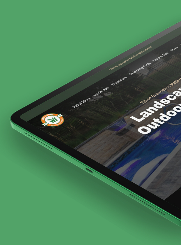 Executive Outdoor Living website shown on an angled tablet, navigation and Landscape Design hero